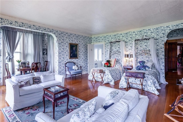 living room with hardwood / wood-style flooring and crown molding