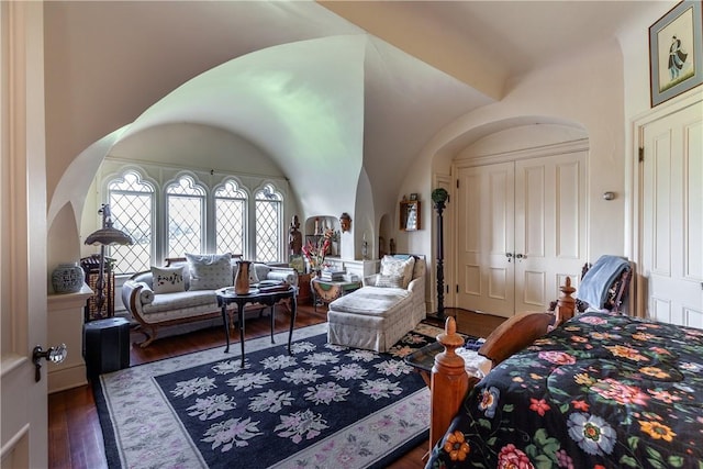 bedroom featuring a closet, dark wood-type flooring, and vaulted ceiling