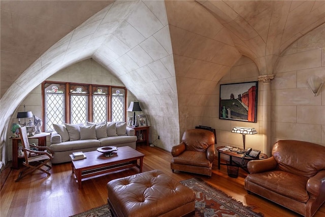 living room with hardwood / wood-style flooring and vaulted ceiling