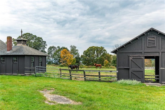 view of yard featuring an outbuilding and a rural view