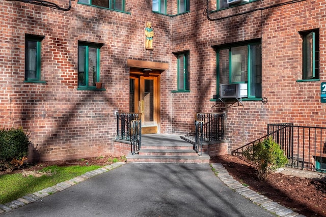 entrance to property featuring cooling unit