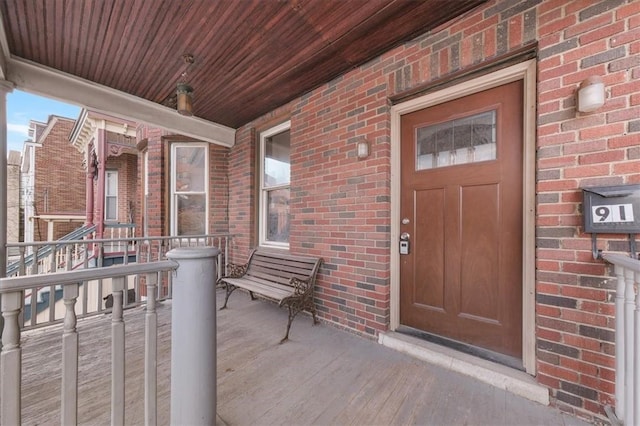 view of exterior entry featuring a porch