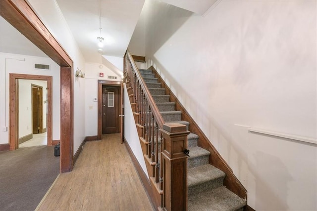 staircase with hardwood / wood-style flooring