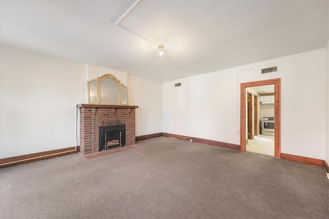 unfurnished living room featuring carpet and a brick fireplace