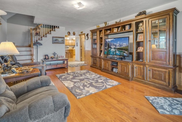 living room with wood-type flooring and a textured ceiling