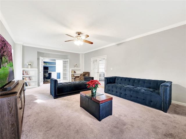 living room with ceiling fan, light colored carpet, crown molding, and french doors