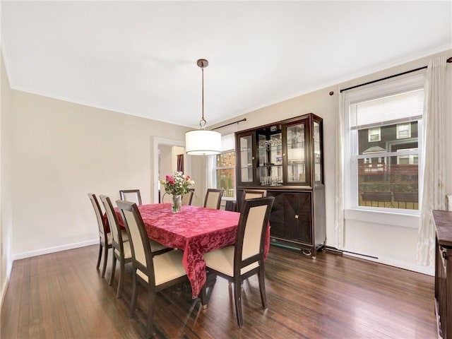 dining room featuring dark hardwood / wood-style flooring and crown molding