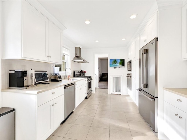 kitchen with white cabinetry, wall chimney exhaust hood, stainless steel appliances, and light tile patterned floors