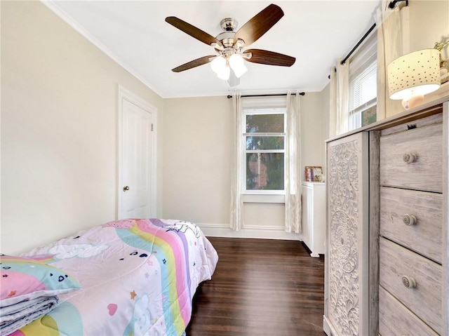 bedroom featuring dark hardwood / wood-style flooring, ceiling fan, and crown molding