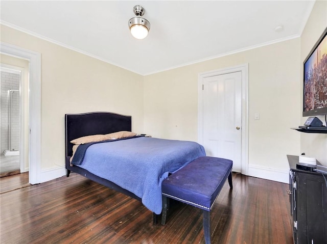 bedroom with crown molding, ensuite bathroom, and dark wood-type flooring