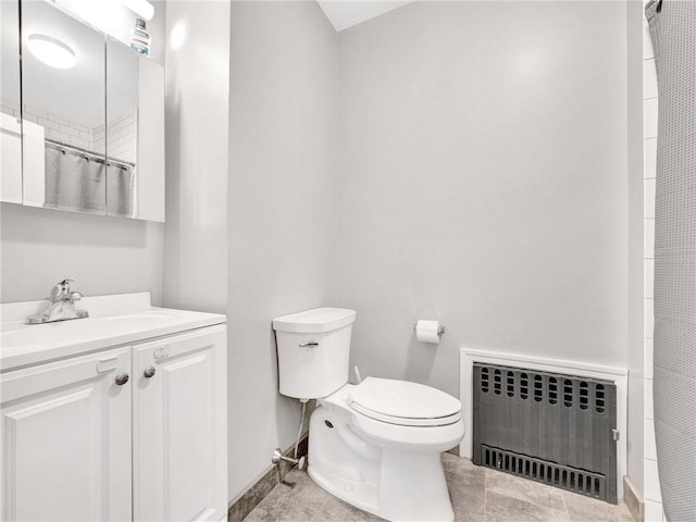 bathroom with vanity, toilet, radiator, and curtained shower