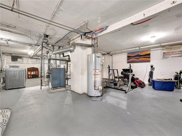 basement featuring gas water heater and washer / dryer