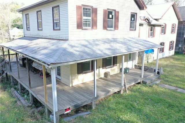 rear view of house featuring covered porch