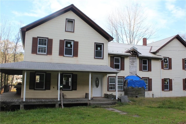 view of front of property with covered porch and a front yard