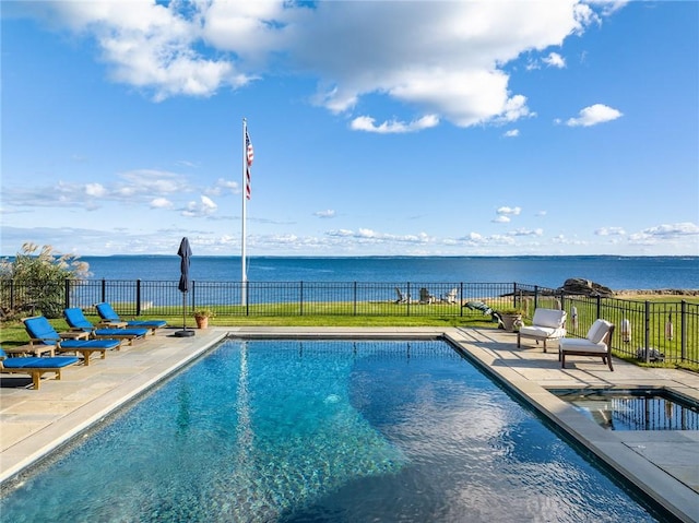 view of swimming pool with a patio area and a water view