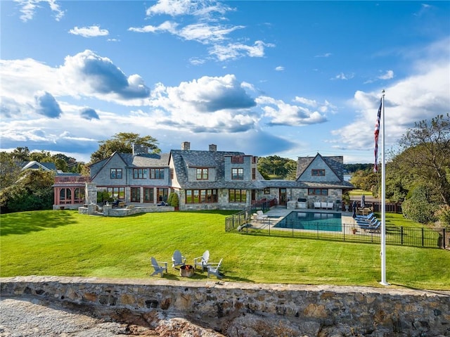 12 Island Dr, Rye, NY 10580 - rear view of house featuring a lawn, a fenced in pool, and a patio