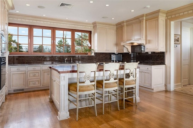 12 Island Dr, Rye, NY 10580 - kitchen with light hardwood / wood-style floors, a wealth of natural light, and ornamental molding