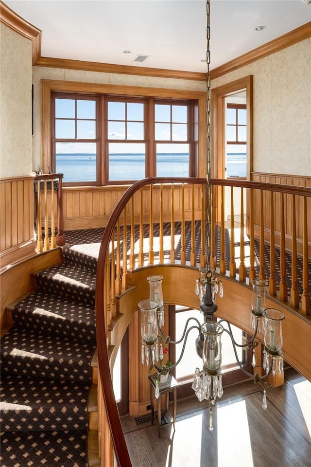 12 Island Dr, Rye, NY 10580 - staircase featuring a water view, wood-type flooring, and crown molding