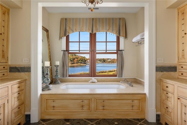 12 Island Dr, Rye, NY 10580 - bathroom with tile patterned flooring, vanity, a water view, and a bathtub