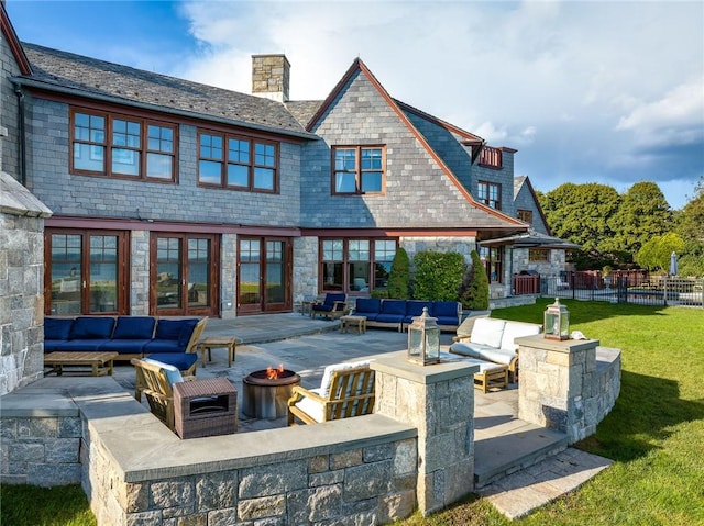 12 Island Dr, Rye, NY 10580 - back of house with a lawn, an outdoor living space with a fire pit, and a patio