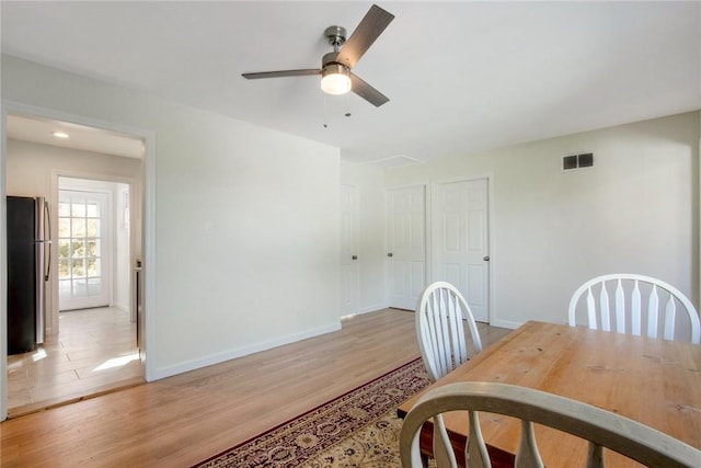 dining room with ceiling fan and light hardwood / wood-style floors