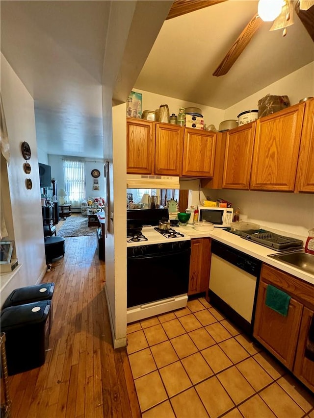 kitchen featuring white appliances, light hardwood / wood-style floors, ceiling fan, and sink