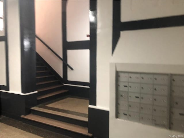 stairs featuring a mail area