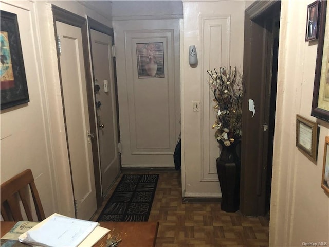 corridor featuring dark parquet flooring