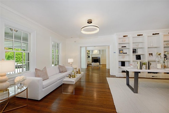 living room with dark hardwood / wood-style flooring and ornamental molding