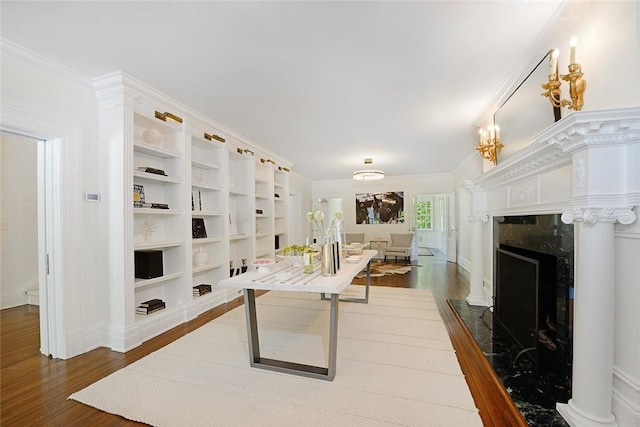 interior space featuring crown molding, hardwood / wood-style floors, and a high end fireplace