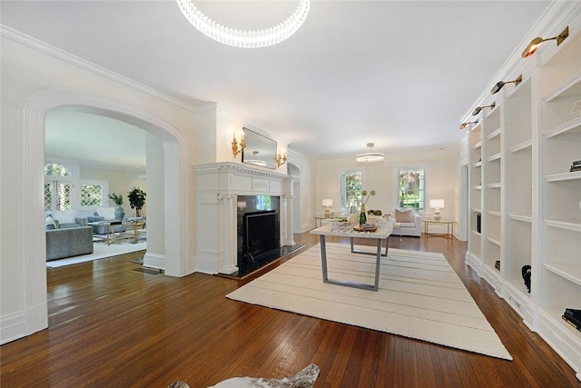 home office with dark hardwood / wood-style flooring and ornamental molding