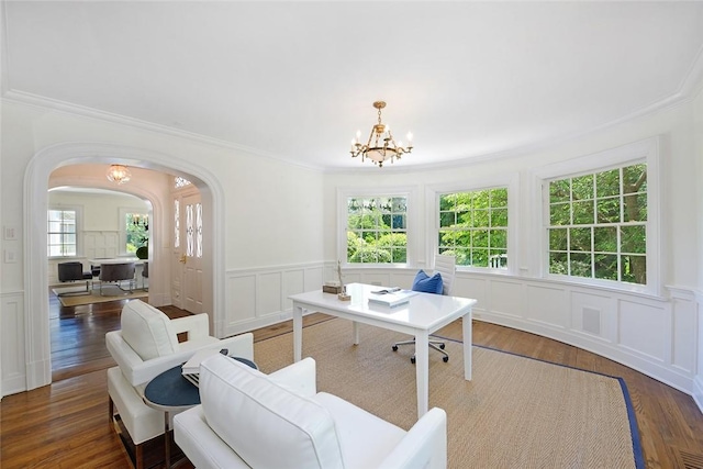 home office with dark wood-type flooring, crown molding, and a notable chandelier