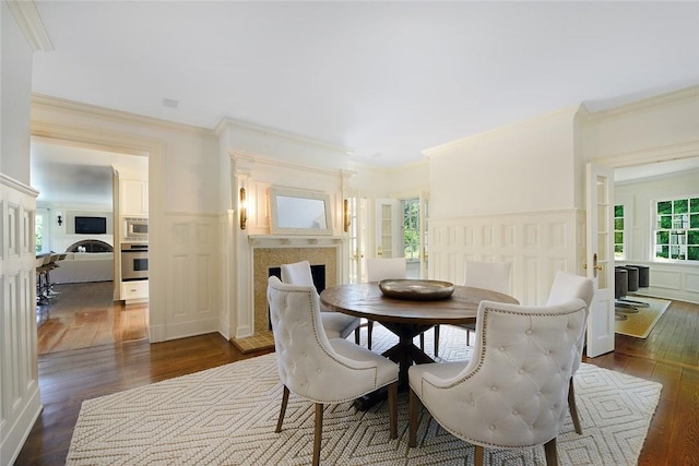 dining room with dark wood-type flooring and ornamental molding