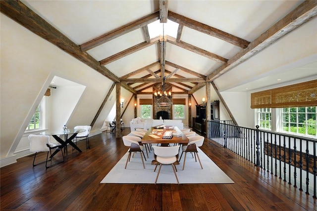 dining room with dark hardwood / wood-style flooring, plenty of natural light, a stone fireplace, and vaulted ceiling with beams