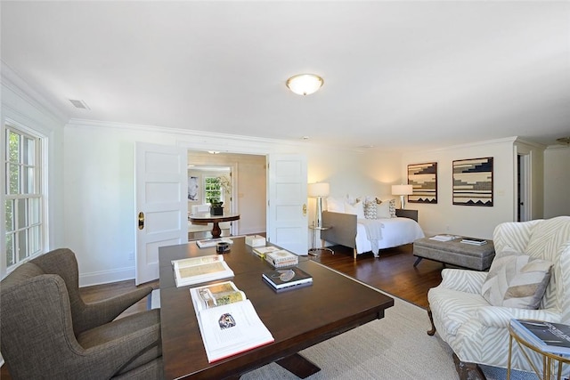 living room featuring dark hardwood / wood-style flooring and crown molding