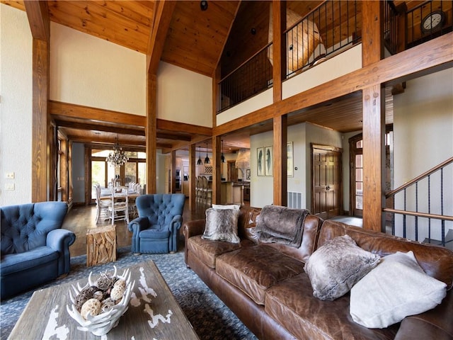 living room with beam ceiling, high vaulted ceiling, wood ceiling, and an inviting chandelier