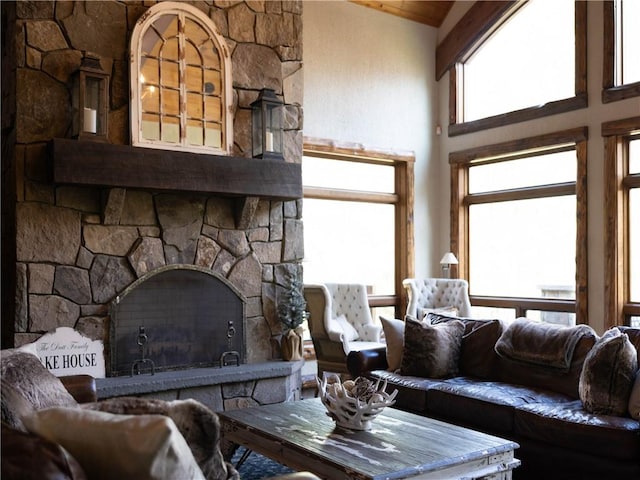 living room with a fireplace and high vaulted ceiling