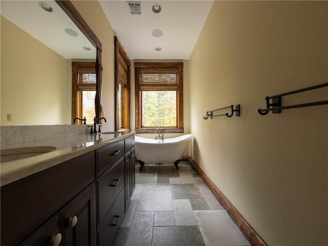 bathroom with vanity and a tub to relax in