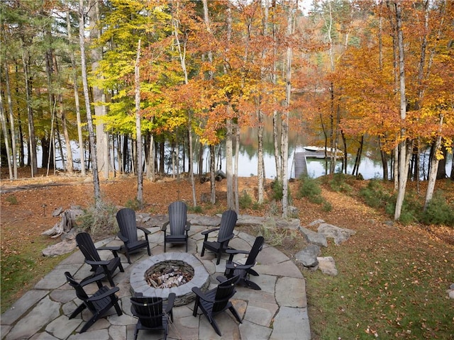 view of patio / terrace with a water view and a fire pit