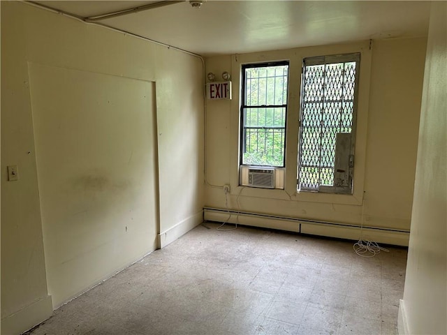 empty room with cooling unit and a baseboard heating unit