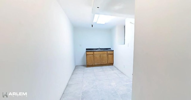 interior space featuring light tile patterned flooring and sink