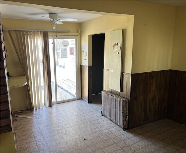 interior space featuring radiator and ceiling fan