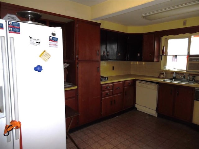 kitchen featuring decorative backsplash, sink, and white appliances