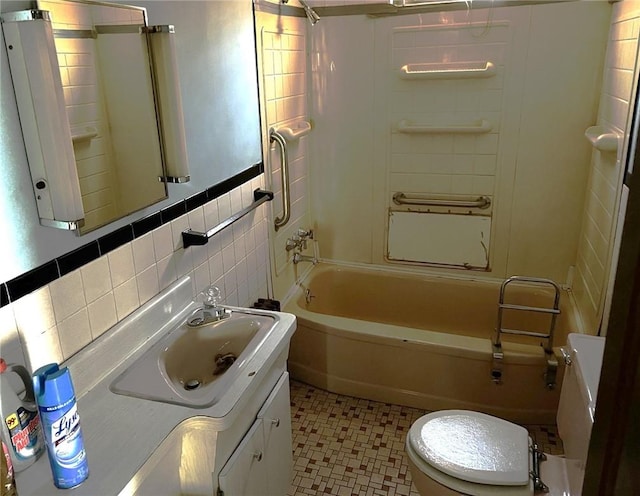 full bathroom with tile patterned floors, vanity, shower / tub combination, tile walls, and toilet