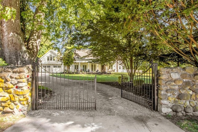 view of gate with a yard