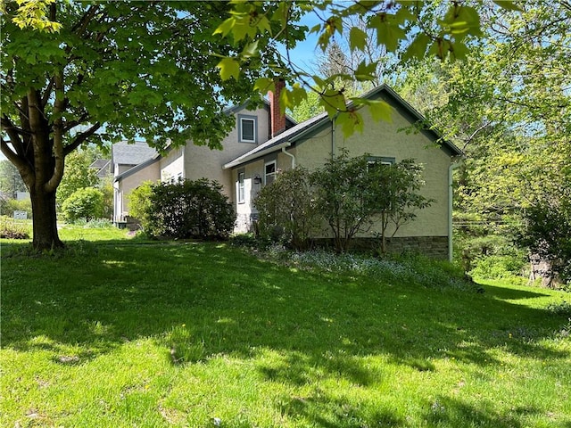 view of property exterior with a yard