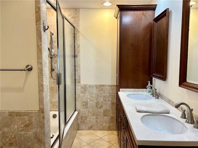 bathroom with tile patterned flooring, vanity, walk in shower, and tile walls