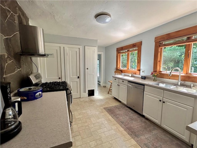 kitchen with gas range oven, exhaust hood, sink, dishwasher, and white cabinetry