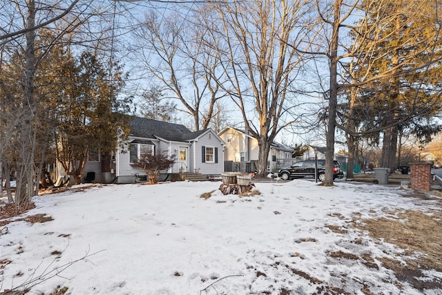 yard covered in snow featuring entry steps