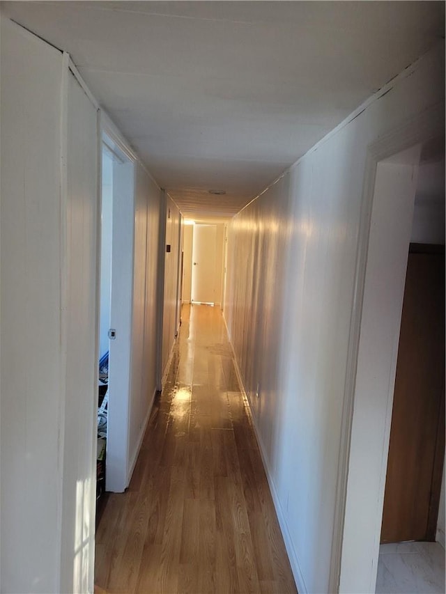 corridor featuring wood finished floors